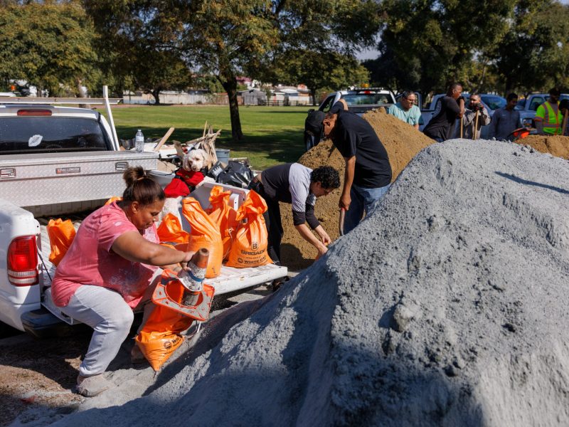 Residents fill sand bags at a park in the recently flooded Southcrest neighborhood as they prepare for the first of two atmospheric weather systems expected to bring heavy rain to San Diego, California, U.S. January 31, 2024. REUTERS/Mike Blake