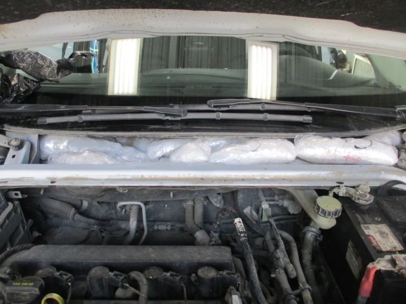 Packages of drugs hidden under the hood of a vehicle. Photo courtesy CBP