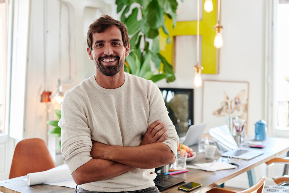 man smiling in office after diversity and inclusion coaching