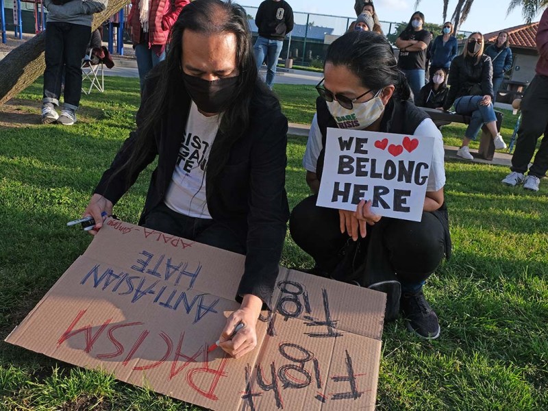 Asian Americans at the prayer vigil prepared signs.