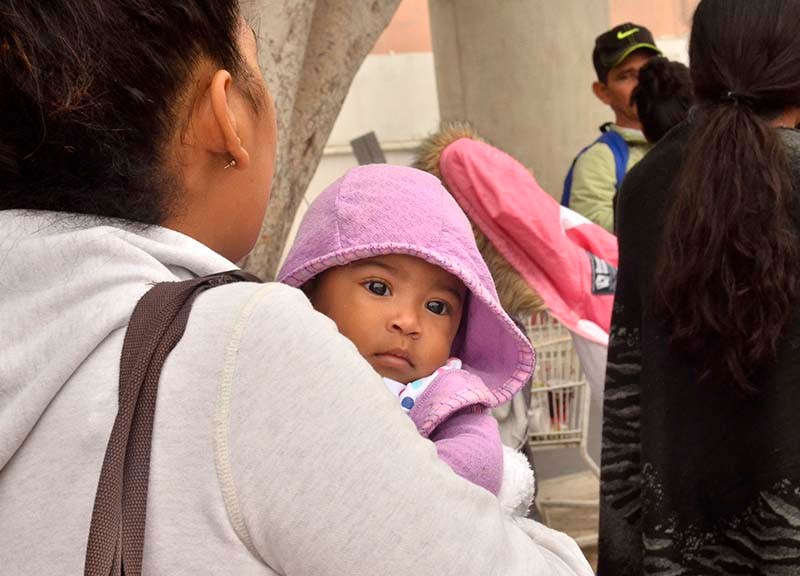 Many women and children from Mexico and Central America waited to see if they would be the next people allowed to enter the U.S.