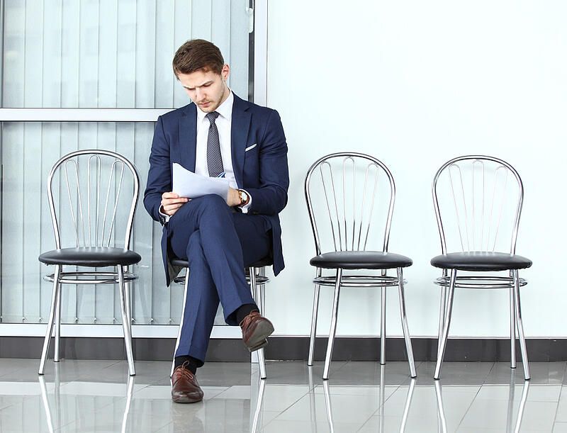 Business-man-ready-for-interview-waiting-in-a-chair-tell-us-about-yourself