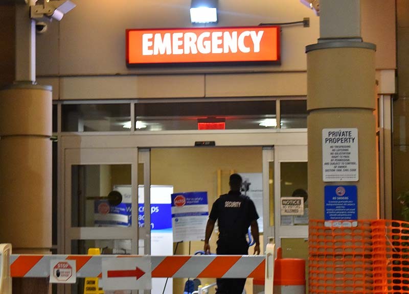 A security officer enters the Scripps Mercy Hospital San Diego emergency entrance.