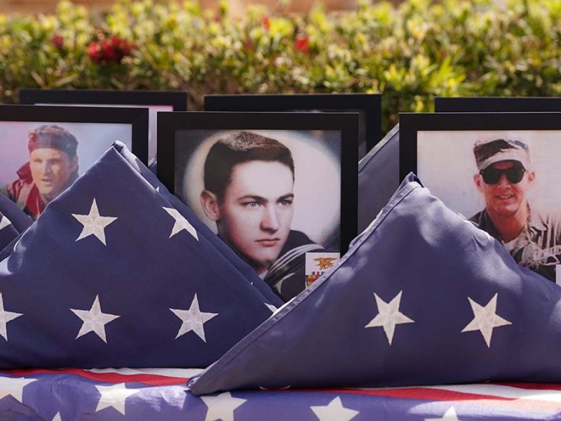 Photos of fallen Naval Special Warfare operatives are displayed. Photo by Chris Stone