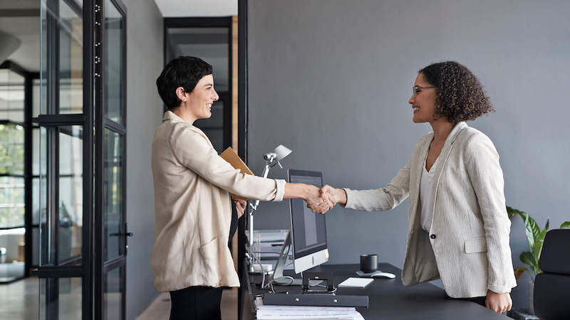 how-to-follow-up-after-an-interview-two-women-shaking-hands