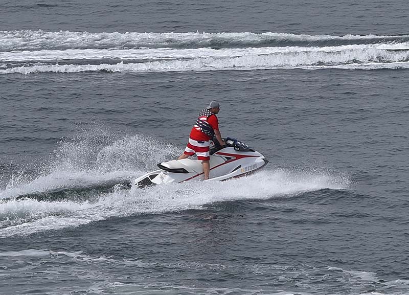 A jet ski rider in patriot clothes takes a spin in San Diego Bay on Memorial Day.