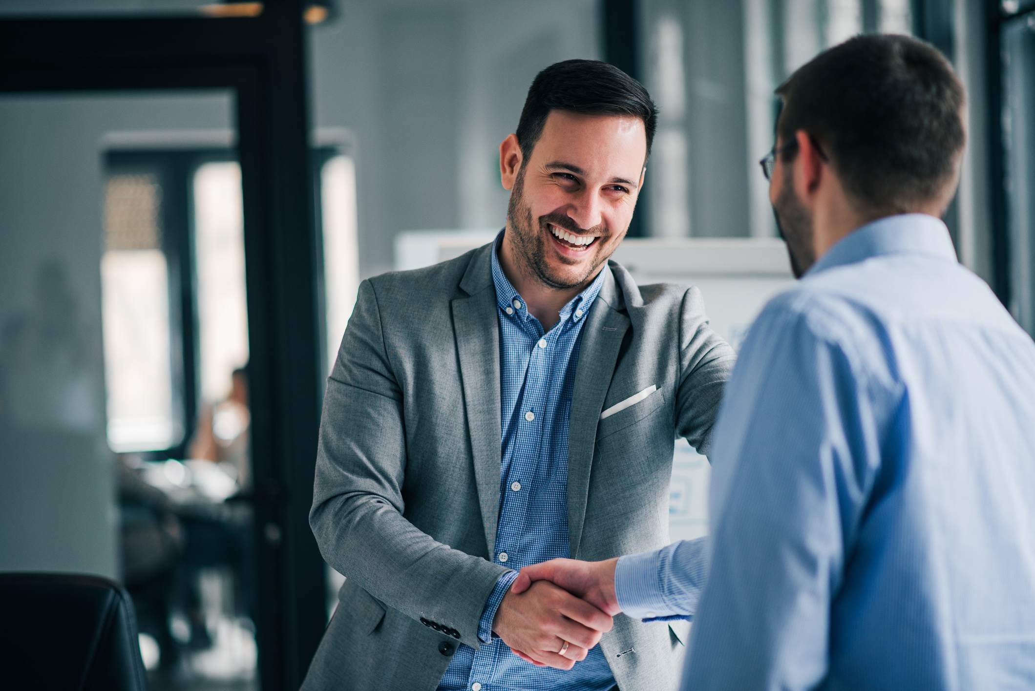 Portrait-of-cheerful-young-manager-handshake-with-new-employee-functional-resume