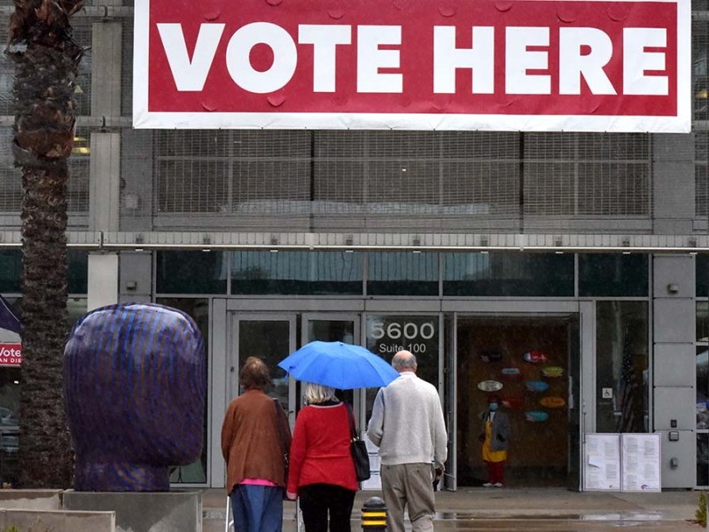 Voters braved the wind and rain to vote. Photo by Chris Stone