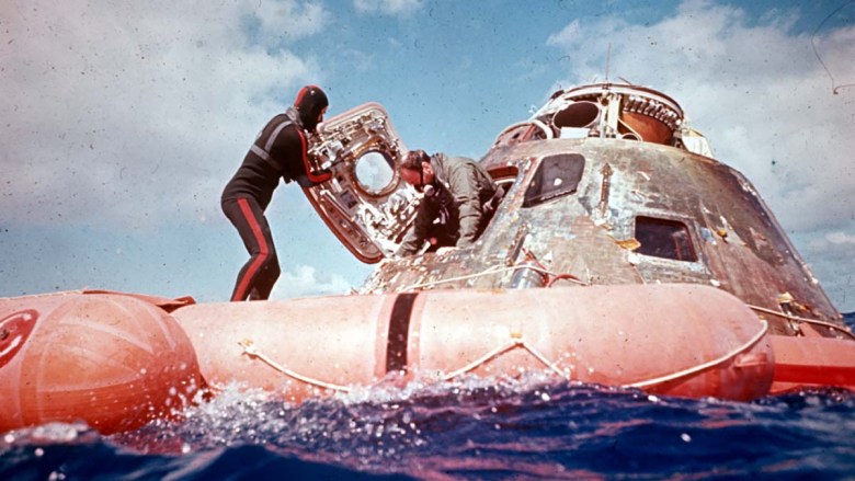 Lt. Robert Rohrbach assisted Apollo CDR Edgar Mitchell out of the command module. Courtesy Robert Rohrbach