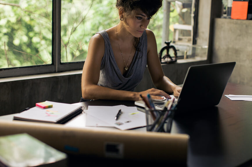 woman-using-laptop-with-notebook-beside-her-employee-retention